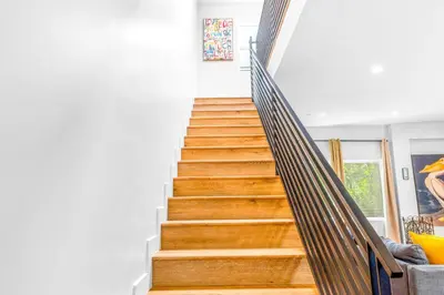 a staircase with a wooden railing in a house at Stylish Sherman Oaks Townhouse 3bed + 3.5bath All Master Suites in Los Angeles