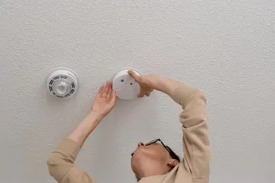 a man is putting a light on a ceiling at Stylish Sherman Oaks Townhouse 3bed + 3.5bath All Master Suites in Los Angeles