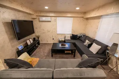 a living room with a couch and a flat screen tv at Pine Mountain Club Family Vacation House in Pine Mountain Club
