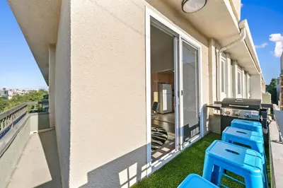a balcony with blue stools on a building at Beverly Hills Penthouse 2 BR Apt with Parking 407 in Los Angeles