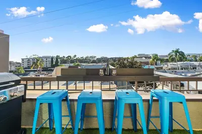 a group of three blue stools in front of a grill at Beverly Hills Penthouse 2 BR Apt with Parking 407 in Los Angeles