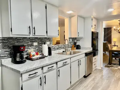 a kitchen with white cabinets and a sink at Glendora Pool Home Retreat in Glendora