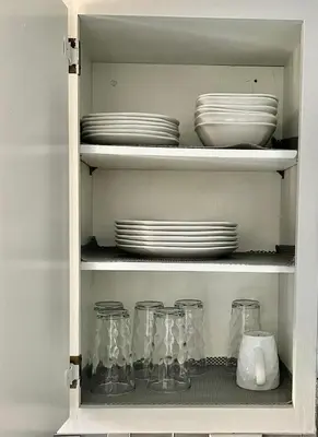 a cupboard with plates and dishes in it at Glendora Pool Home Retreat in Glendora