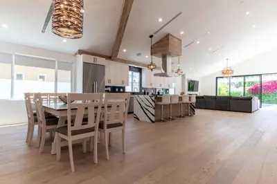 a kitchen and living room with a table and chairs at Universal Studio Stellar Home with pool and jacuzzi in Los Angeles
