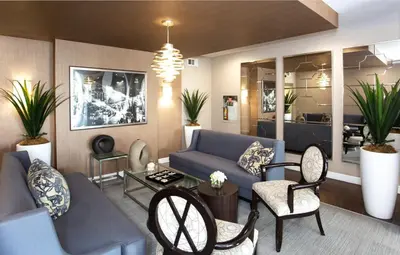 a living room with a blue couch and a table at Beverly Hills 2 bed 2 bath Penthouse with Den and Parking 414 in Los Angeles