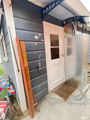 an open door to a house with a garage at Little Bettys Cottage in Torrance