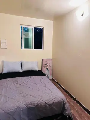 a bedroom with a bed and a window at Zen Home in Santa Ana
