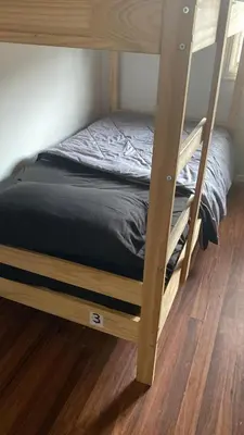 a bunk bed in a room with a wooden floor at Zen Home in Santa Ana