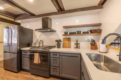 a kitchen with stainless steel appliances and a sink at Stunning Cabin with Private Deck in Big Bear City