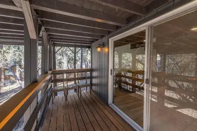 a screened in porch of a house with windows at Stunning Cabin with Private Deck in Big Bear City