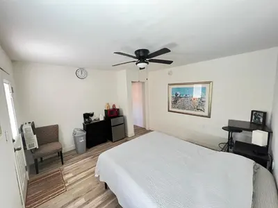 a bedroom with a bed and a ceiling fan at Little Betty's Casita in Torrance