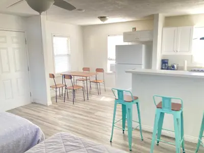 a kitchen with a table and chairs in a room at Little Betty’s Hideaway in Torrance