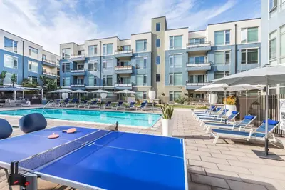 a pool with a ping pong table in front of a building at Marina Del Rey 1br w lounge gym spa nr marina LAX-1074 in Los Angeles