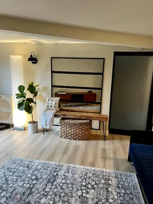 a living room with a couch and a table at NEW Modern apt w/pool & hot tub in nature in Thousand Oaks