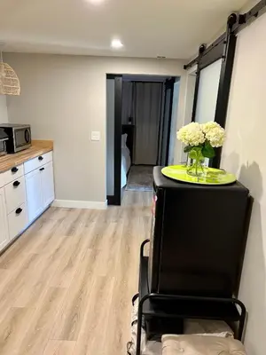a kitchen with a table with a vase of flowers on it at NEW Modern apt w/pool & hot tub in nature in Thousand Oaks