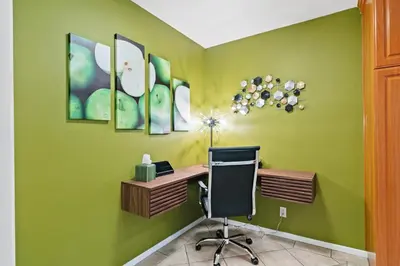 an office with green walls and a desk with a chair at Beverly Hills Gem 1 BR Apt with Parking 218 in Los Angeles