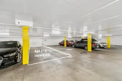 a parking garage with several cars parked in it at Beverly Hills Gem 1 BR Apt with Parking 218 in Los Angeles