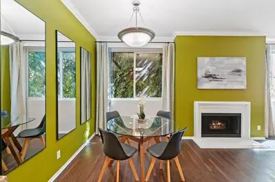 a dining room with green walls and a glass table and chairs at Beverly Hills Gem 1 BR Apt with Parking 218 in Los Angeles