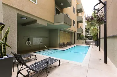 a swimming pool in the courtyard of a building at Beverly Hills Gem 1 BR Apt with Parking 218 in Los Angeles