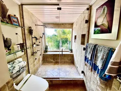 a bathroom with a shower and a toilet and a window at Boho Chic Malibu Retreat Estate Salt Pool + Yoga in Malibu