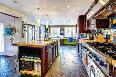 a kitchen with a counter and a stove top oven at Boho Chic Malibu Retreat Estate Salt Pool + Yoga in Malibu