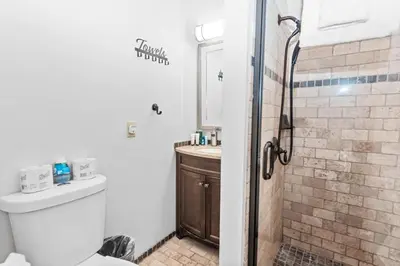 a bathroom with a shower and a toilet and a sink at Mountain Getaway in Big Bear Lake