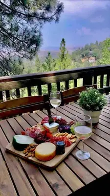 a tray of food and glasses of wine on a wooden table at Panoramic Views at Deer Crest Lodge in Lake Arrowhead