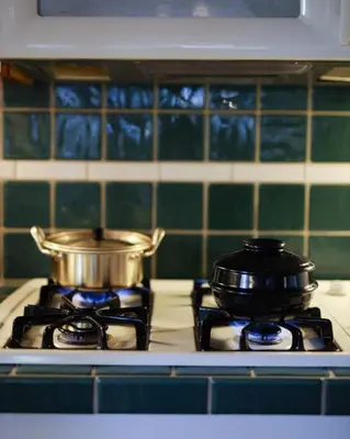 two pots and pans on a stove in a kitchen at Namu Cabin in Big Bear Lake