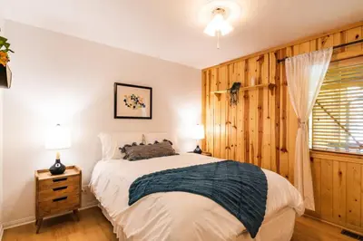 a bedroom with a large bed and a window at Namu Cabin in Big Bear Lake