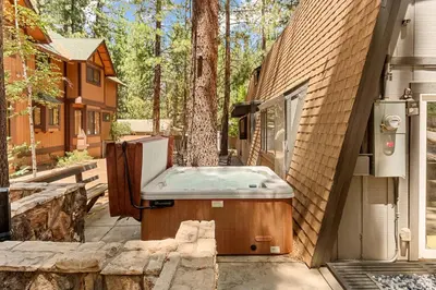 a hot tub sitting on the side of a house at The 99 Pines Walk to Snow Summit Hot Tub in Big Bear Lake