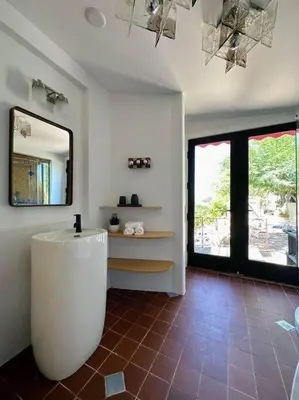 a bathroom with a tub and a mirror on the wall at Malibou Lake Oasis in Agoura Hills