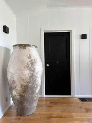 a large vase sitting on the floor in front of a door at Malibou Lake Oasis in Agoura Hills