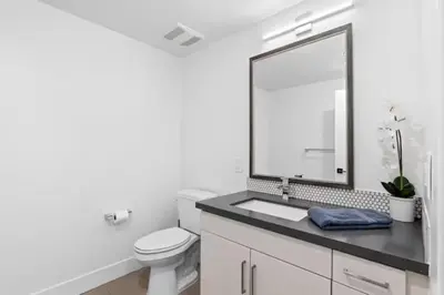 a white bathroom with a sink and a mirror at Ruby Tide - Two Floor Airy 2BR Marina Side Exclusive Amenities in Los Angeles