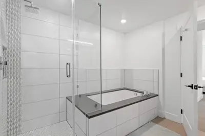 a bathroom with a tub and a glass shower at Ruby Tide - Two Floor Airy 2BR Marina Side Exclusive Amenities in Los Angeles