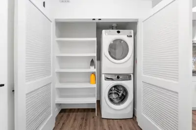 a washer and dryer in a white closet at Ruby Tide - Two Floor Airy 2BR Marina Side Exclusive Amenities in Los Angeles
