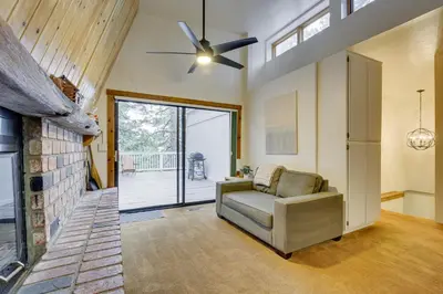 a living room with a couch and a ceiling fan at The Abby Cabin Restful Running Springs Retreat! in Running Springs