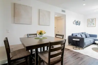 a living room with a table and a couch at Luxury 2Bed/2Bath Apt in West Hollywood w/ Rooftop in Los Angeles