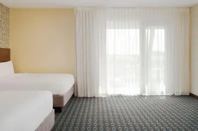 a hotel room with two beds and a window at Fairfield Inn & Suites by Marriott Los Angeles LAX/El Segundo in El Segundo