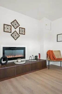 a living room with a fireplace and a couch at Luxury 6BR Retreat Fast WIFI, Dedicated Workspaces in Hesperia