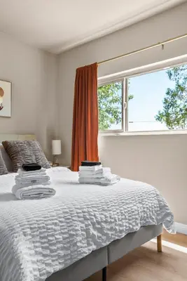 a white bedroom with a bed with a window at Luxury 6BR Retreat Fast WIFI, Dedicated Workspaces in Hesperia