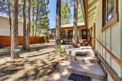 a house with a porch with trees on it at Central Big Bear Lake Retreat with Private Hot Tub! in Big Bear Lake