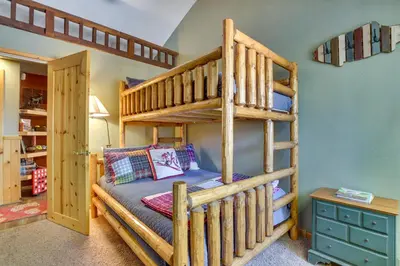 a bedroom with a bunk bed with a ladder at Central Big Bear Lake Retreat with Private Hot Tub! in Big Bear Lake