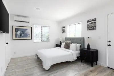 a white bedroom with a bed and a table at Sunny Studio in the Heart of Venice - B in Los Angeles