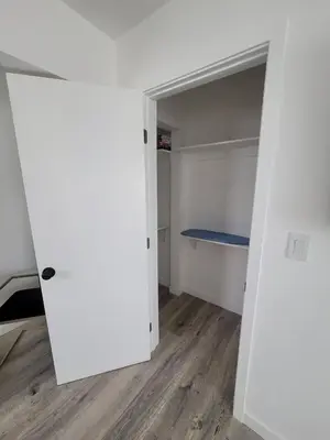 an empty room with a white closet with a blue bench at Sunny Studio in the Heart of Venice - B in Los Angeles