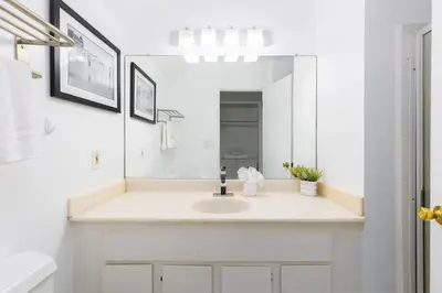 a white bathroom with a sink and a mirror at Sunny Studio in the Heart of Venice - B in Los Angeles