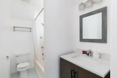 a bathroom with a sink and a toilet and a mirror at Sunny Studio in the Heart of Venice - B in Los Angeles