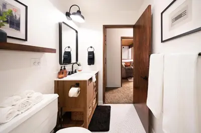 a bathroom with a toilet and a sink and a tub at Large A-Frame Cabin (9 Beds, AC, + Lake Access) in Lake Arrowhead