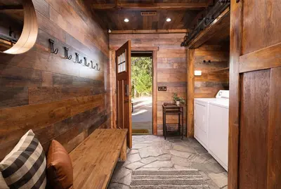 a hallway of a house with a wooden wall at Large A-Frame Cabin (9 Beds, AC, + Lake Access) in Lake Arrowhead