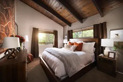 a bedroom with a large bed and a window at Large A-Frame Cabin (9 Beds, AC, + Lake Access) in Lake Arrowhead
