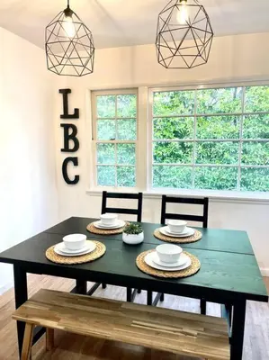a dining room with a green table and chairs at Beautiful Bright Condo Steps Away from the Beach in Long Beach